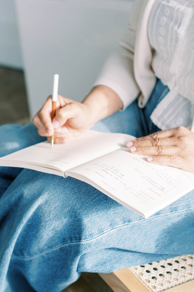woman writing in a wedding planning journal